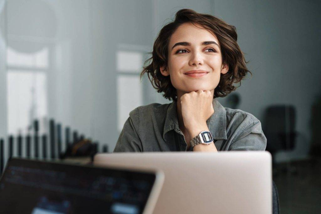 Woman smiling at laptop