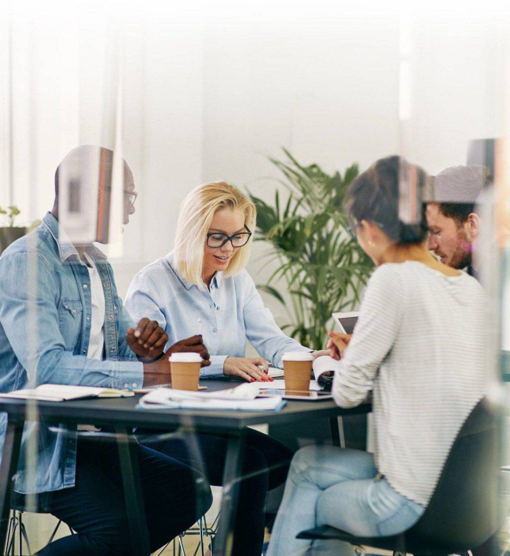 team working round desk in modern office